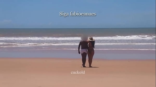 (EXCERPT) Hot interracial fun from howife. Hot wife in a bikini shows off on the beach and grabs the black guy's cock in white swim trunks and receives a massage in front of her cuckold.